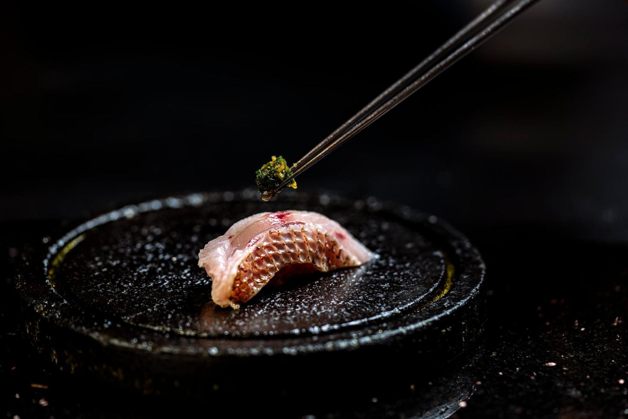 Vie Hotel Bangkok, Mgallery Kültér fotó A piece of sushi being seasoned with shichimi tōgarashi